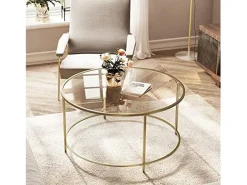 Mesa de centro redonda Valora con estructura de acero dorado y tablero de cristal