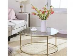 Mesa de centro redonda Valora con estructura de acero dorado y tablero de cristal